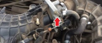 The arrow indicates the throttle assembly installed on the car